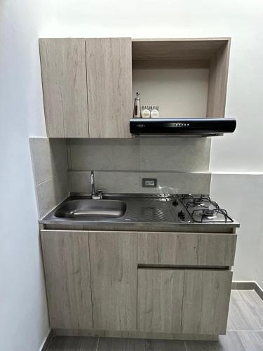 a kitchen with a sink and a stove at Casa Vernazza in Manizales