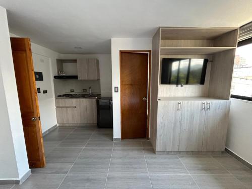 a room with a kitchen with a door and a floor at Yellow House in Manizales