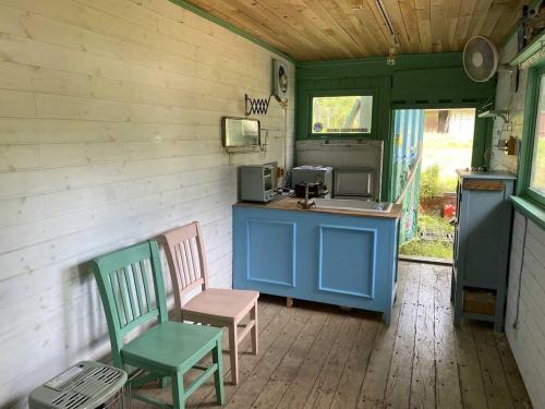 a kitchen with two chairs and a counter and a stove at Little North Campground - Vacation STAY 69019v in Kajikazawa