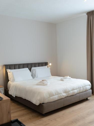 a bedroom with a large bed with white sheets at VILLA ISABELLA Ospedale Cisanello in Pisa
