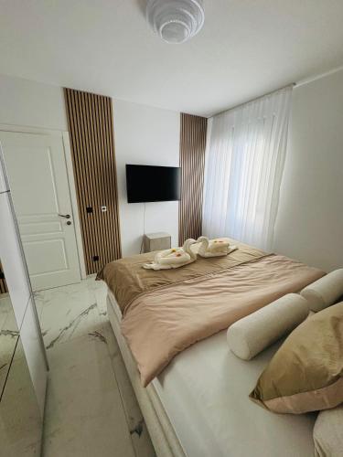 a bedroom with a bed with two towels on it at Villa Nova Bar in Bar