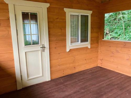 an empty room with a door and two windows at Kitakaruizawa Acorn Mountain Ichibanboshi Campsite - Vacation STAY 53268v in Kita-karuizawa