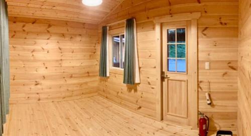 a wooden room with a door and a window at Kitakaruizawa Acorn Mountain Ichibanboshi Campsite - Vacation STAY 53268v in Kita-karuizawa
