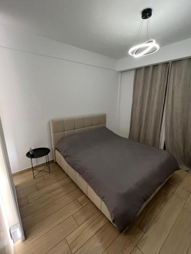 a bedroom with a large bed and a table at Riverside in Florina
