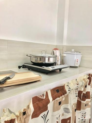 a kitchen counter with a pan on top of it at Serenity home sweet home in Tuguegarao City