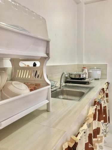 a kitchen with a sink and a counter top at Serenity home sweet home in Tuguegarao City