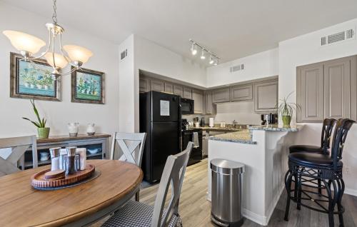 a kitchen and living room with a table and chairs at Newly Renovated Condo in Mesquite