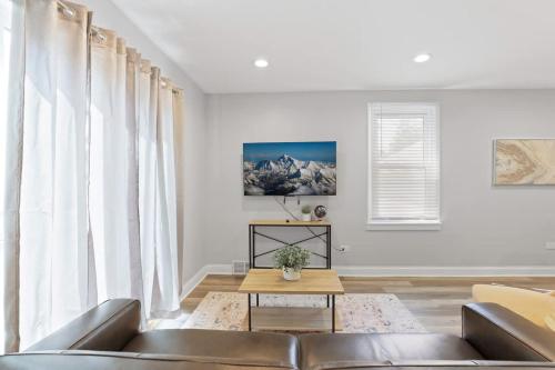 a living room with a couch and a table at 3 BD 2 BA Home near Ohare Airport sleeps 8 in River Grove