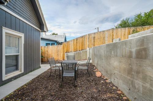 a patio with a table and chairs next to a fence at Station 130! Cozy Downtown Home w Fire Pit in Colorado Springs
