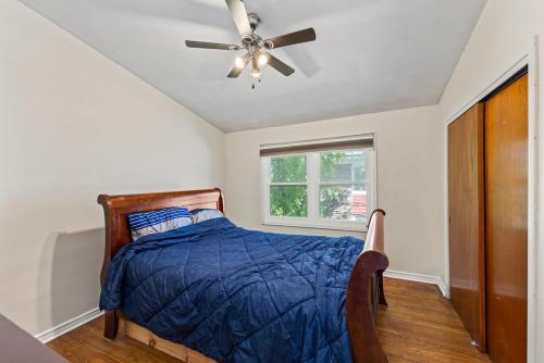 a bedroom with a bed and a ceiling fan at 4 Bedroom full house with 4 car parking in Kingston
