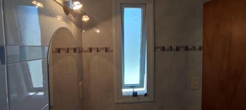 a bathroom with a window and a shower at RelaxMza in Mendoza