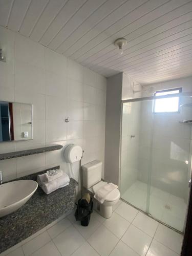 a bathroom with a toilet and a sink and a shower at San Fernando Hotel in São Luís