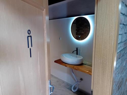 a bathroom with a sink and a mirror at Kuća za proslave Marković in Baranjsko Petrovo Selo