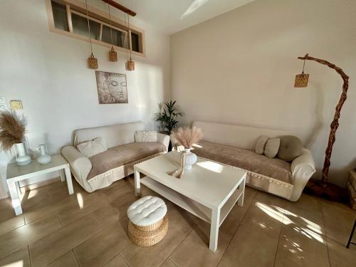 a living room with two couches and a table at SK studios & apartments in Neo Klima