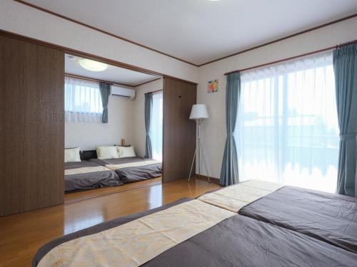 En eller flere senge i et værelse på Misaki Guesthouse - Vacation STAY 20495