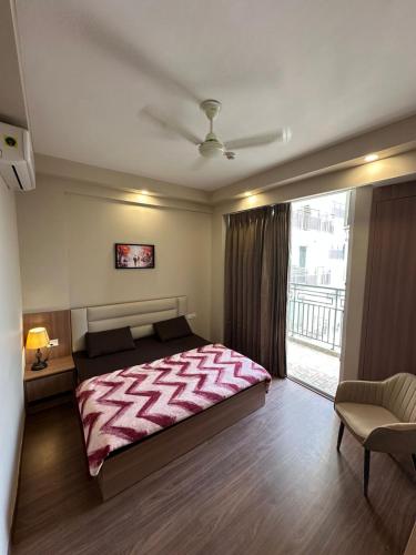 a bedroom with a large bed and a balcony at Street dream homestay in Greater Noida