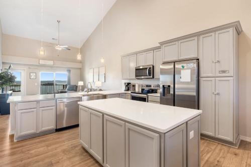 a kitchen with white cabinets and a white counter top at The Lakeview Penthouse - 10ppl in Branson