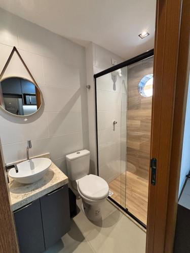 a bathroom with a toilet and a sink and a shower at Azzure Apartmento 103 Intermares in Cabedelo