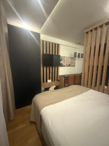 a bedroom with a white bed and a desk at N-LUX 66 MILMARI kopaonik in Kopaonik
