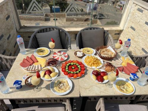 a table with a bunch of food on it at Continental Pyramids Terrace Hotel in Cairo