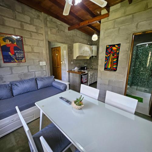 een woonkamer met een tafel en een blauwe bank bij Gorriones Libres in Villa Gesell