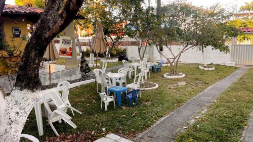 a group of white chairs and tables with umbrellas at El Gringo in Cabo de Santo Agostinho