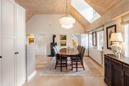 a dining room with a table and chairs at Thatched country escape - Aarhus in Lystrup
