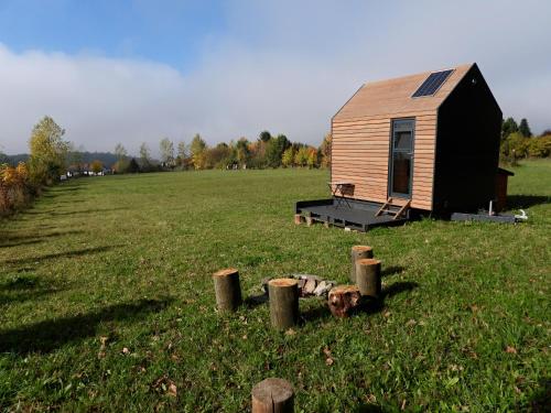 a small wooden cabin in a field of grass at Políčko in České Budějovice