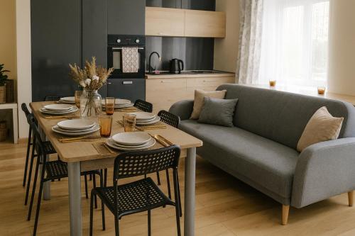 a living room with a table and a couch at TANIE NOCLEGOWANIE in Katowice