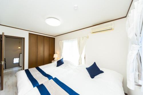 Postel nebo postele na pokoji v ubytování Ａｗａｊｉ Ｇａｒｄｅｎ Ｈｏｕｓｅ ｉｎ Ｓｕｍｏｔｏ - Vacation STAY 81970v