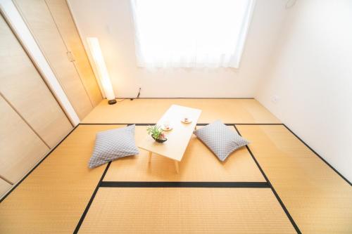 a room with a table and two pillows at Awaji Riverside Terrace in Shizuki - Vacation STAY 81986v in Shizuki