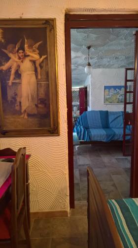 a room with a painting of a woman on a wall at Tamerici House in Montecastrilli