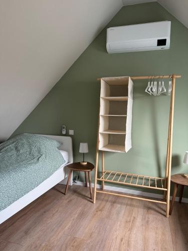 a bedroom with a bed and a book shelf at Casa Del Faro in Westkapelle
