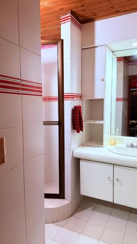 a bathroom with a sink and a mirror at Finca 5 Continentes - Cerca MatroCable ARVI in Guarne