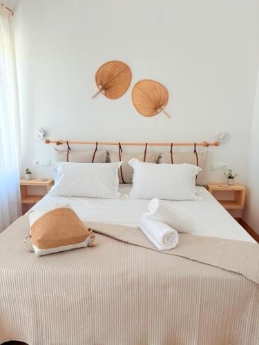 a bedroom with a bed with two towels on it at Athina's Cozy Guest House in Kamisianá