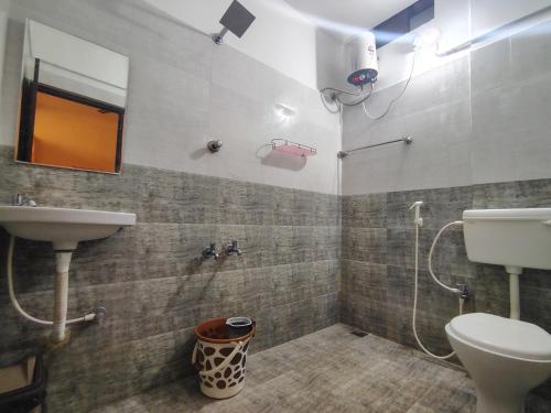 a bathroom with a shower and a toilet and a sink at The Hotel Eden Beach in Puducherry