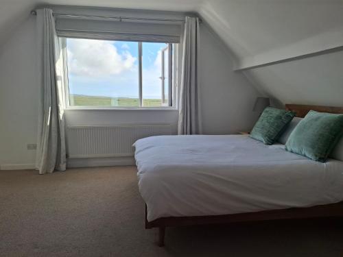 a bedroom with a bed and a large window at 4 Bedroom House in Saltdean, Brighton in Brighton & Hove