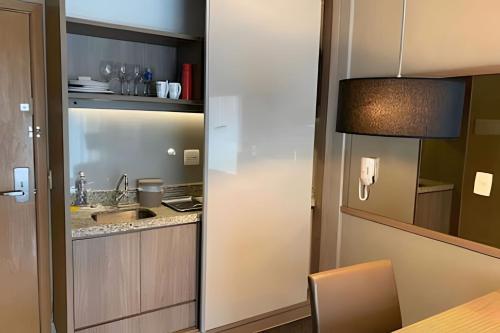 a kitchen with a sink and a counter at Brisas do Lago - Apartamentos in Brasilia