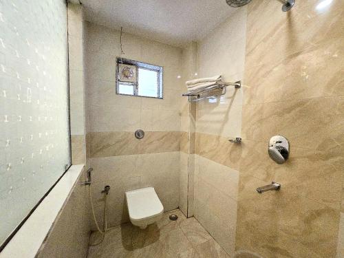 a bathroom with a shower with a toilet at Kuber - Palace Premium # Restaurant- Lift and Free Parking Facilities - Fully Air Conditioning Premium Room in Puri
