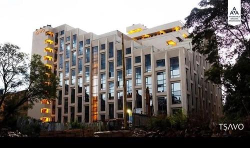 a large white building with a lot of windows at Tsavo in Nairobi