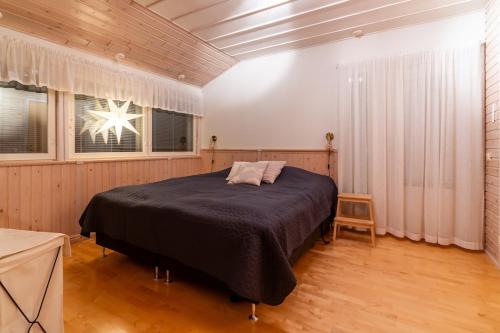 a bedroom with a large bed in a room at Arctic Escape Near Santa Claus Village in Rovaniemi