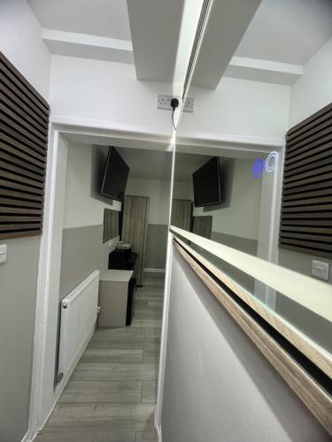 a hallway in a building with a long corridor at Plaza London Hotel in London