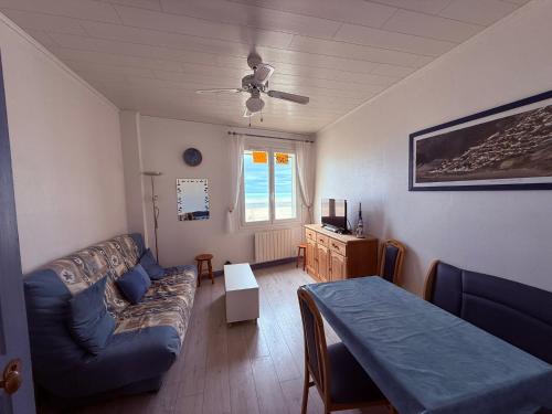 a living room with a couch and a table at Sea View in Quend-Plage