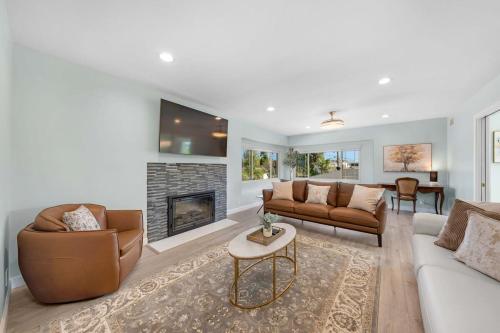 a living room with two couches and a fireplace at Family Hilltop luxe retreat with breathtaking views in La Mesa