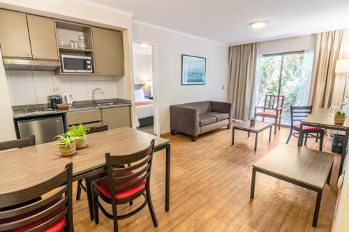 a living room with a kitchen and a dining room at Geotel Calama in Calama