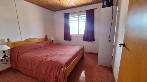 En eller flere senge i et værelse på Aiken Alojamiento