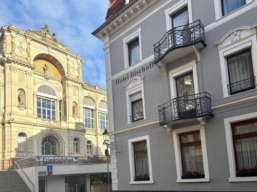 a white building with balconies on the side of it at Hotel Bischoff in Baden-Baden