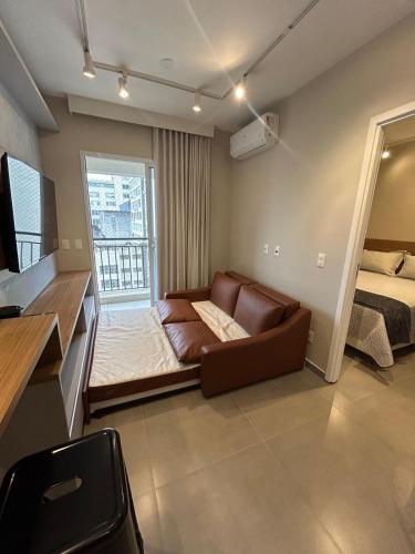 Una cama o camas en una habitación de Studio moderno na Santa Ifigênia - 1212