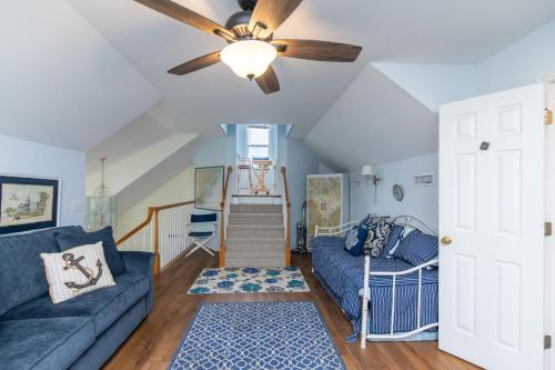 a living room with a couch and a ceiling fan at Cupola House in Edisto Island