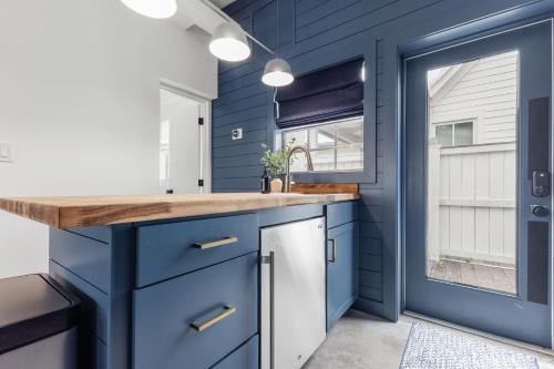 a kitchen with blue cabinets and a sink at La Casita - Steps from 7th Ave in Tampa